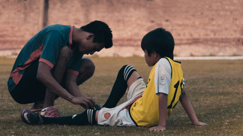 Coach tying shoelace